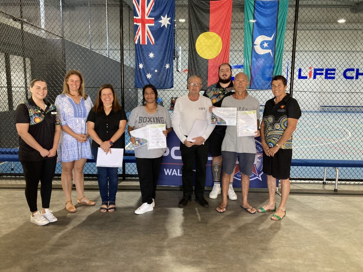 Group of people standing together holding certificates